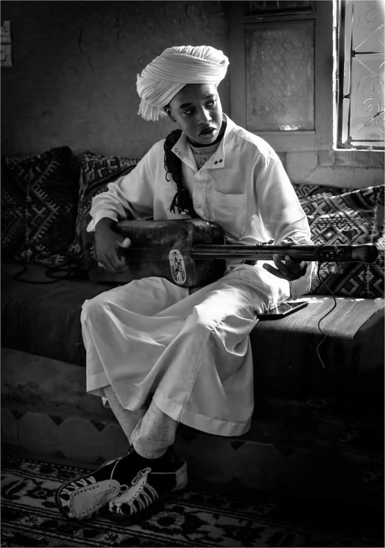 2025 Annual Champion For Print  Playing The Guembri By Paul MacKay